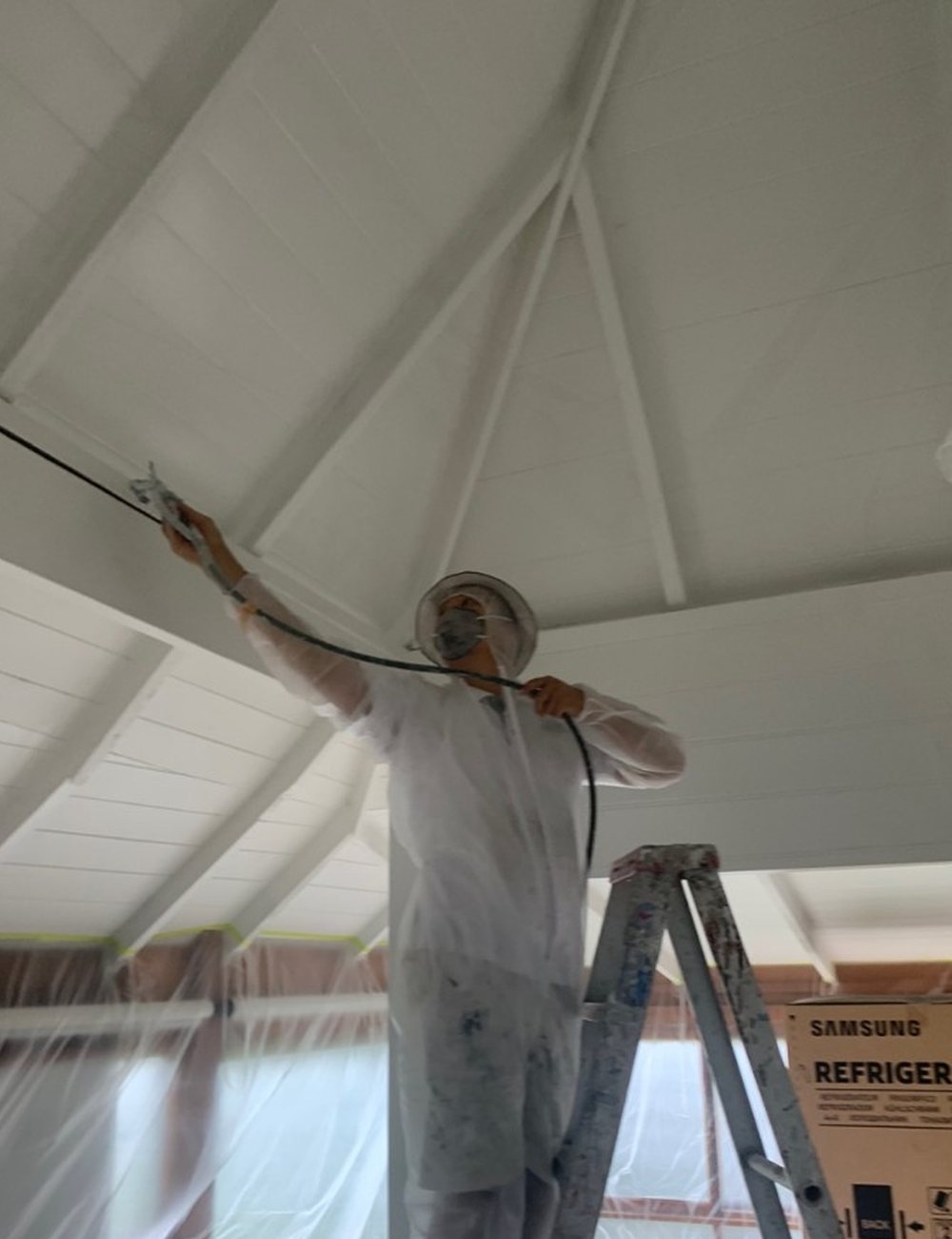 Painting a high ceiling from a ladder