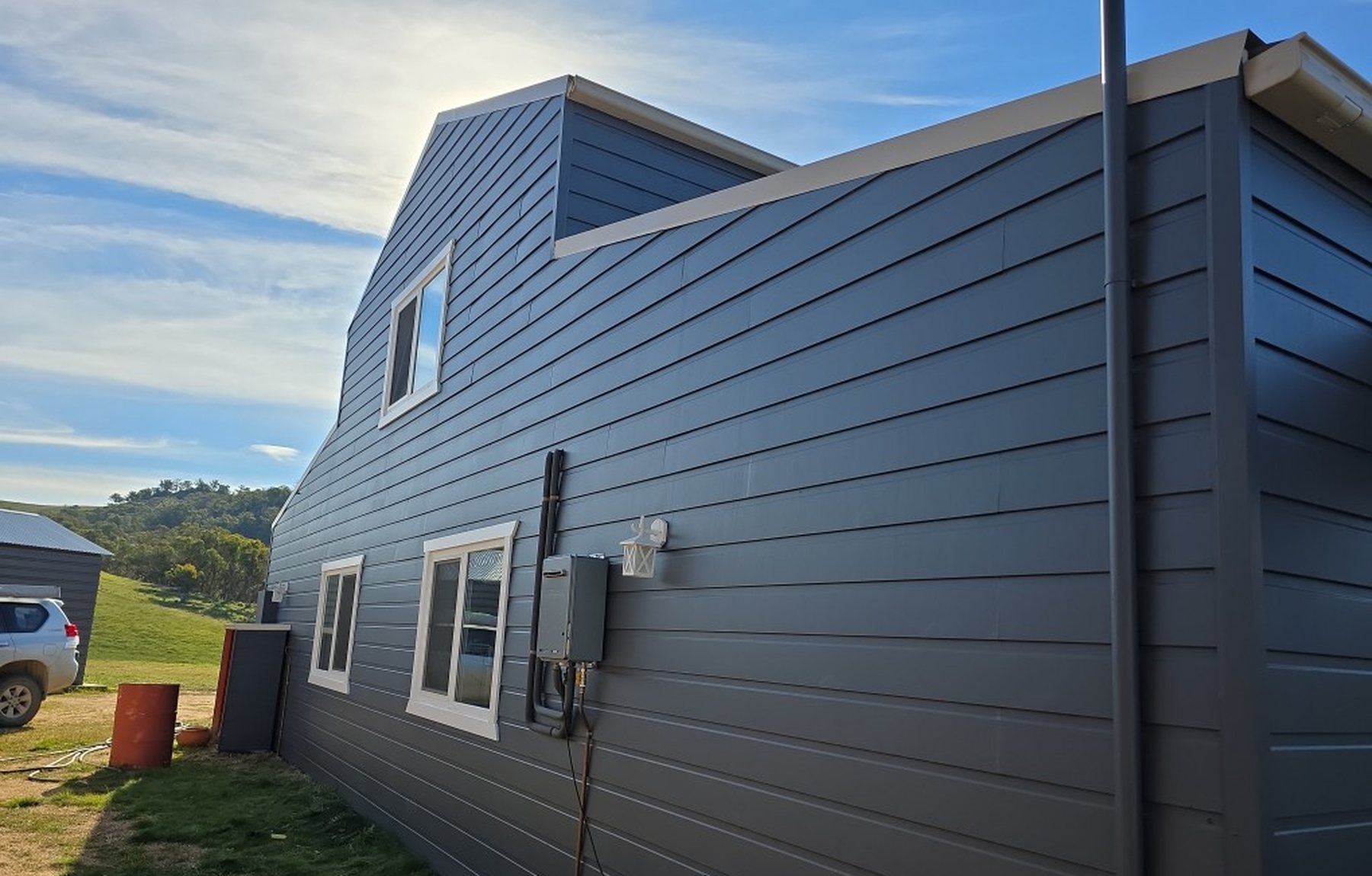 Two-storey weatherboard exterior finished in deep navy