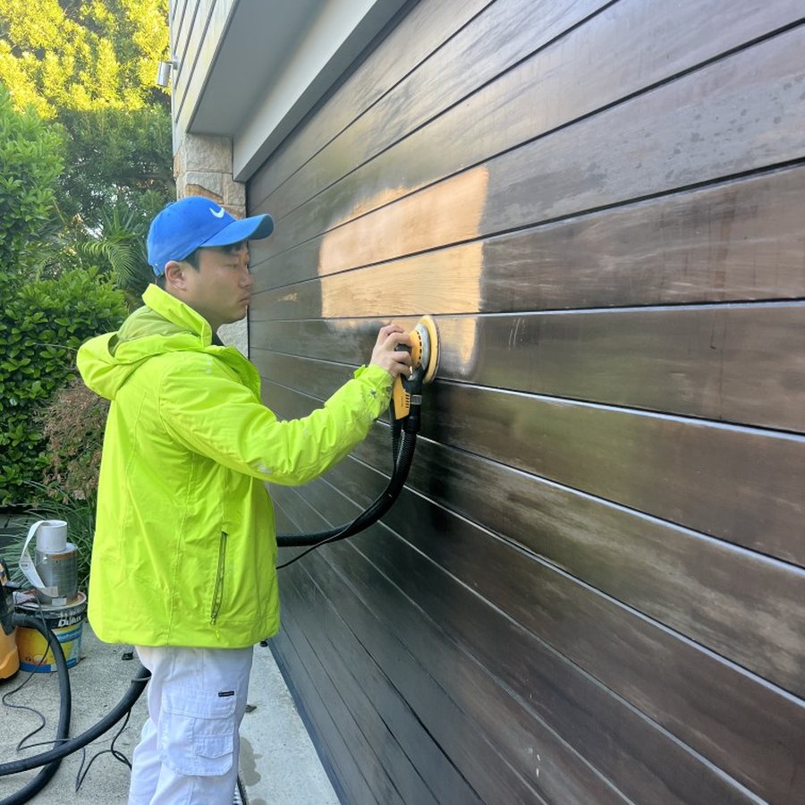 Sanding weatherboard before painting